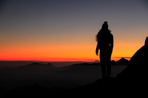 Free Silhouette of a Person at Sunset  Stock Photo