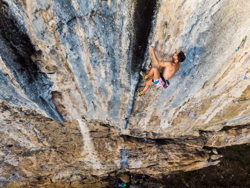 Free A rock climber demonstrates skill and bravery scaling a steep limestone wall in Italy. Stock Photo