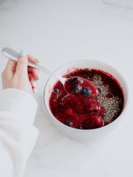 A vibrant berry smoothie bowl topped with chia seeds, perfect for a healthy breakfast.