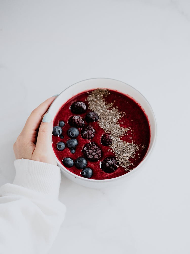 A Person Holding A Fruit Breakfast Bowl