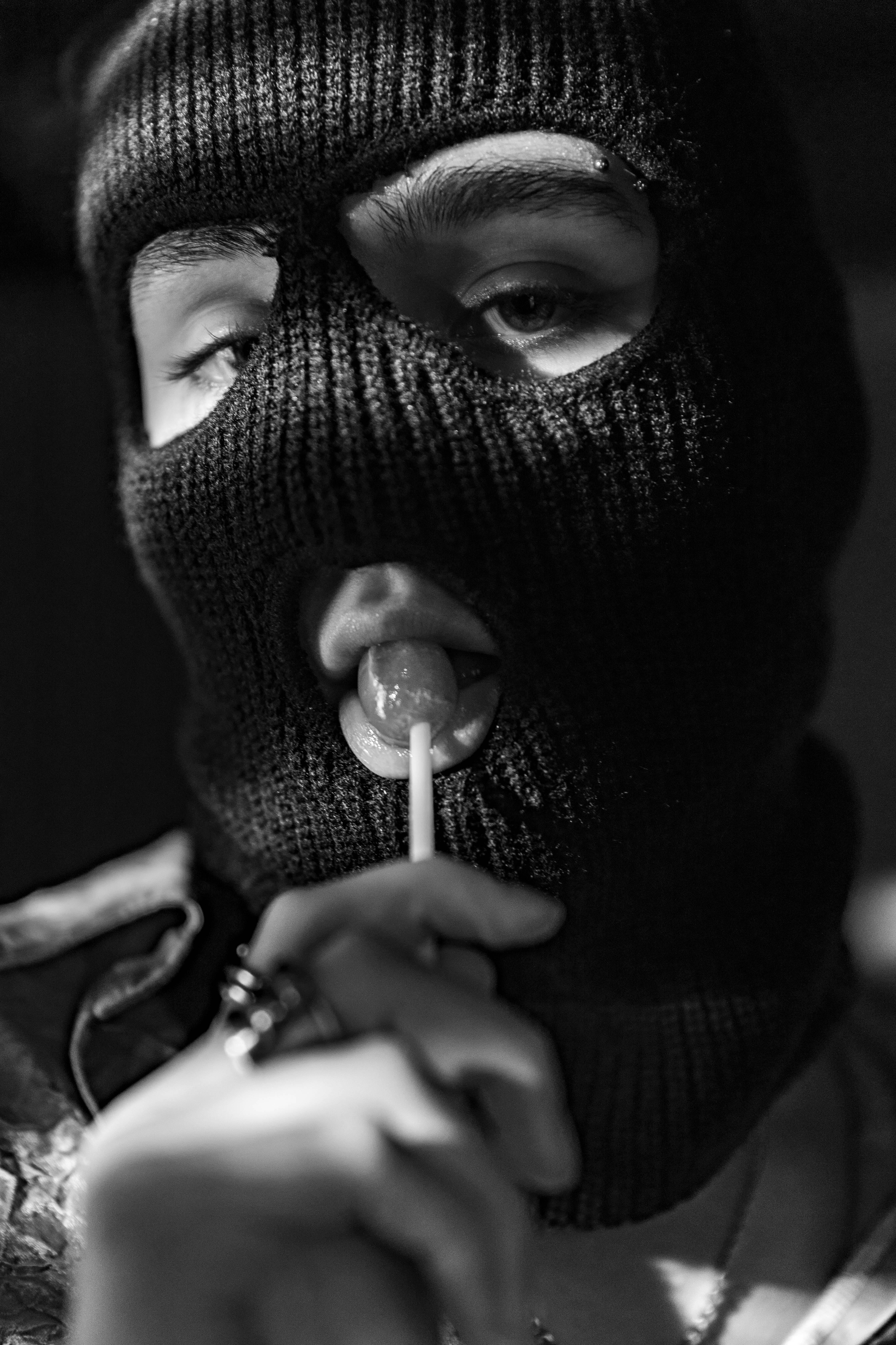 Person Wearing Ski Mask Eating Lollipop · Free Stock Photo, image size:4480x6720