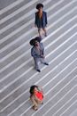 Three People Standing on Striped Floor 