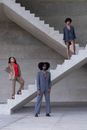 2 Women and Man Standing on Gray Concrete Stairs