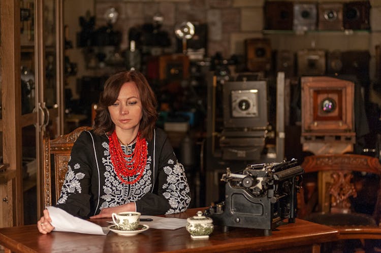 Woman Sitting In Vintage, Decorated Room