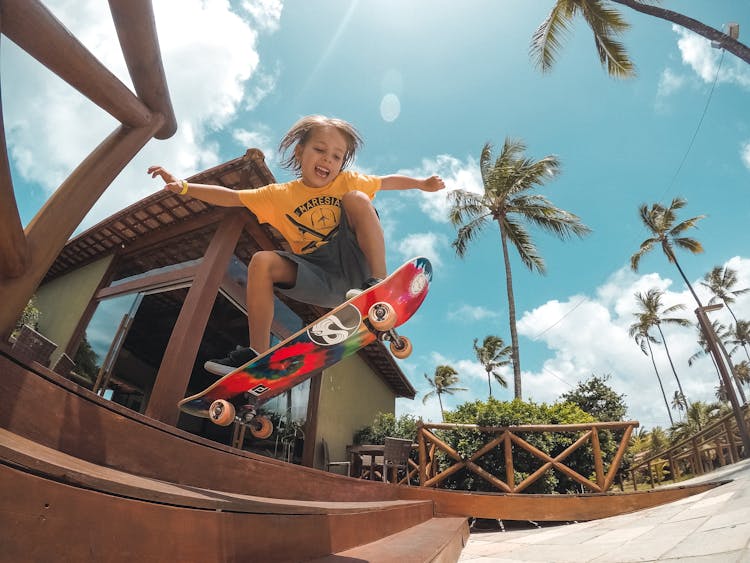 Boy On A Skateboard Jumping On Stairs