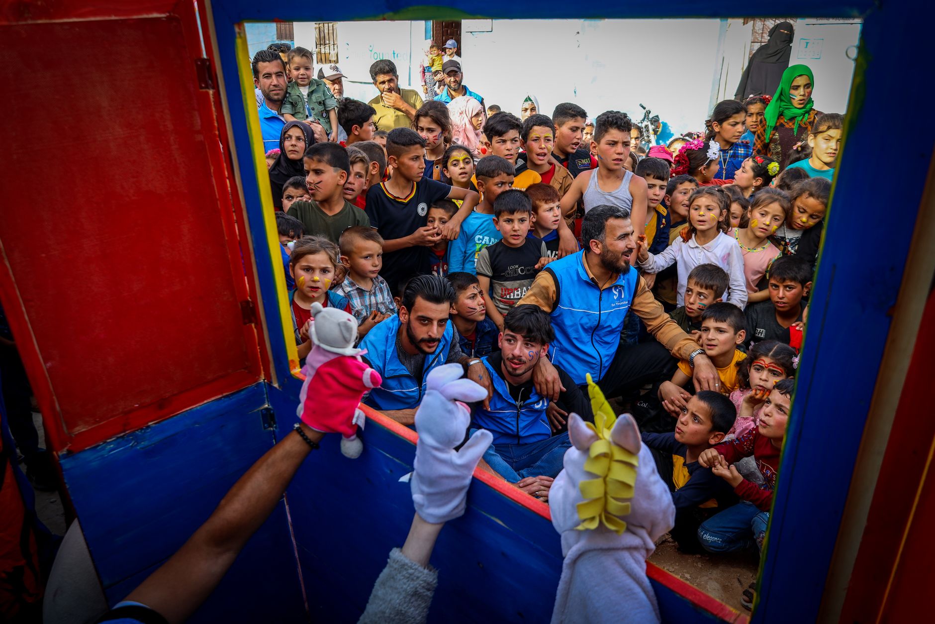 university fresher week entertainment Egypt — Vibrant puppet show draws a crowd of enthusiastic children in Idlib, Syria, cre