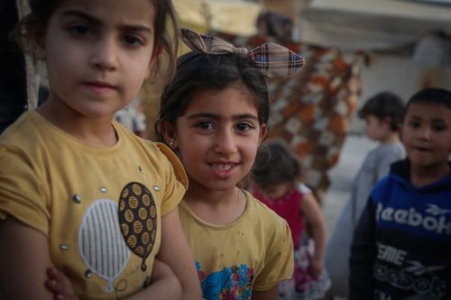 Free Group of smiling children outdoors in Idlib, Syria enjoying a casual moment. Stock Photo