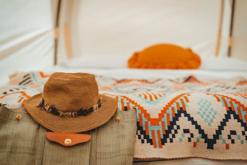 Hat and Blanket on Bed