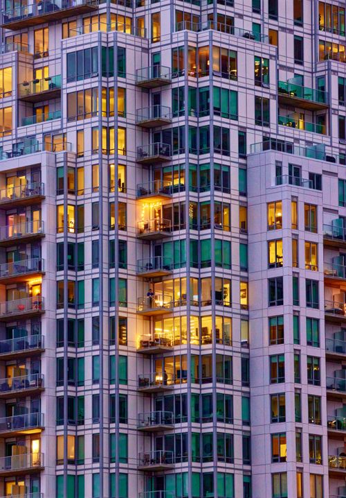 Free Detailed view of a lit high-rise residential building in Halifax during dusk, showcasing urban life. Stock Photo