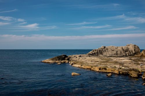 Free Captivating view of Sokcho's coastline with rocky formations and a serene blue sea under a clear sky. Stock Photo