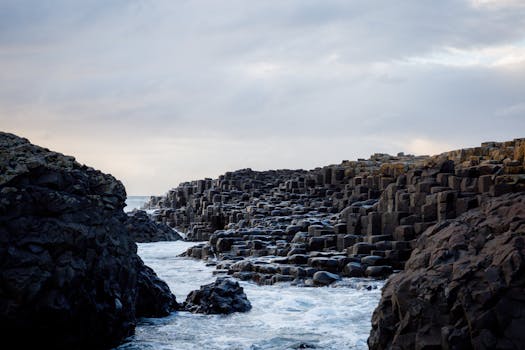Majestic view of Giant's Causeway with rocky formations and ocean waves in Northern Ireland.
