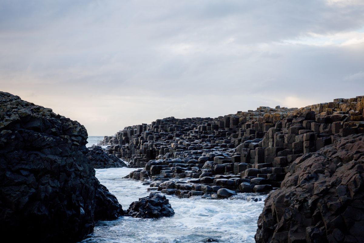 Rocky formations and ocean waves at the Giant's Causeway in Northern Ireland
