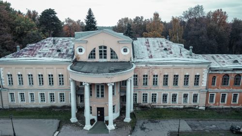 Free Explore the architectural beauty of an abandoned historic building surrounded by lush trees. Stock Photo