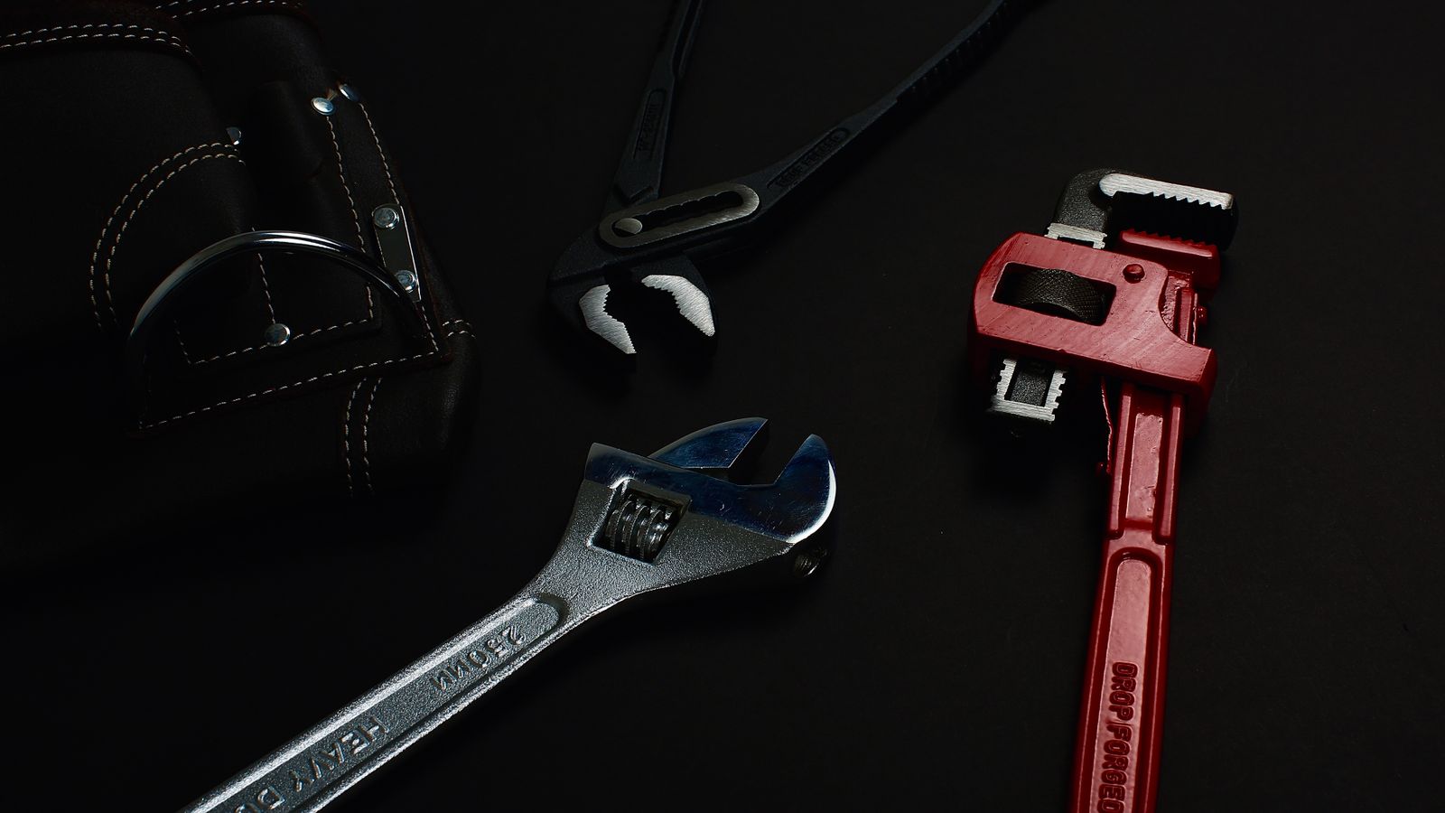 Plumbing wrenches and tools used for water heater repairs