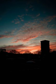 A stunning silhouette of a building against a vibrant sunset sky in Toronto, Canada.