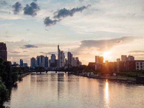 Free Beautiful sunset over Frankfurt's skyline with a river view, highlighting modern architecture. Stock Photo