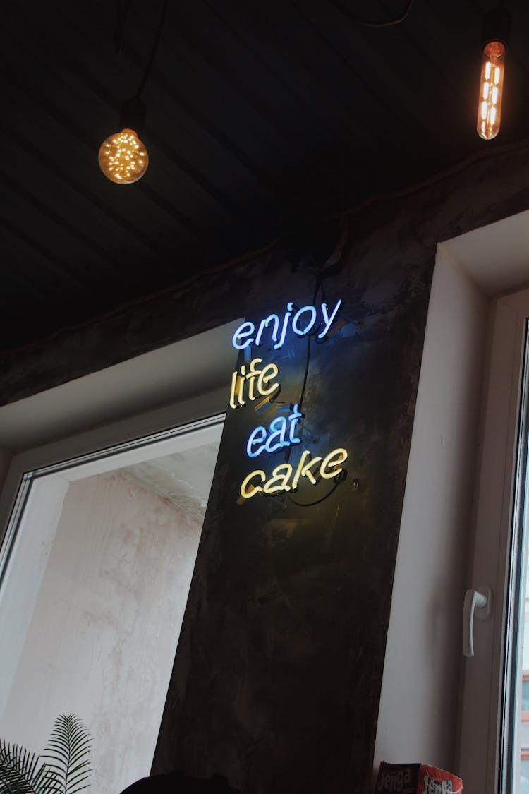 Illuminated Signage On Wall Of A Shop