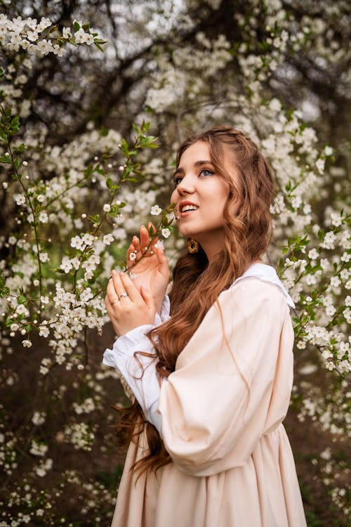 Beautiful Woman in Dress Near White Flowers 