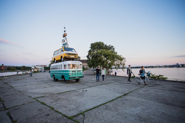 White And Teal Van Surrounded With People