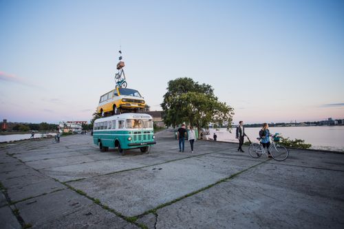 Free Unique urban scene of vintage vehicles stacked by the waterfront at sunset, capturing street life. Stock Photo