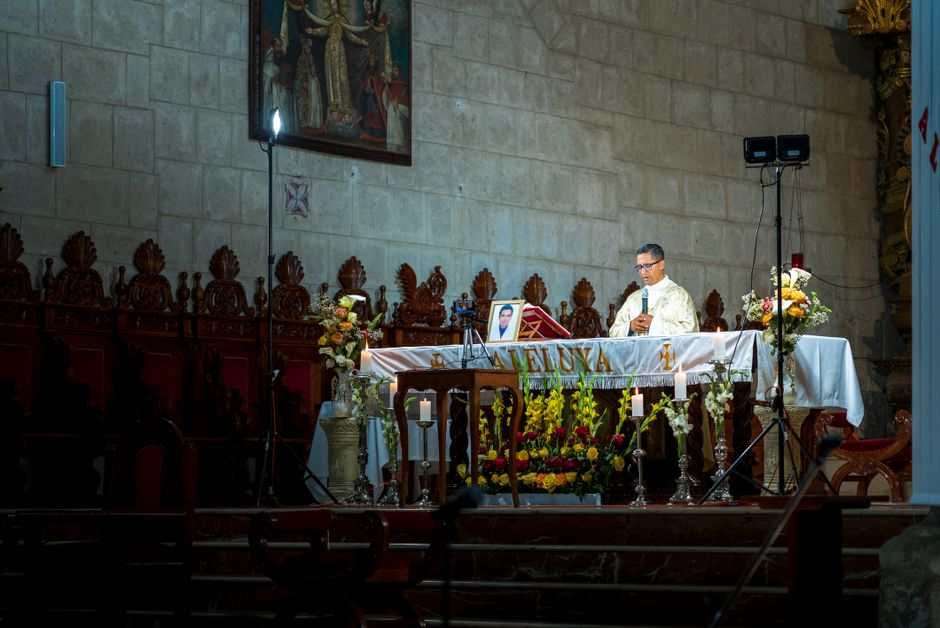 A priest conducting a Catholic mass ceremony inside a church in Cajamarca, Peru.