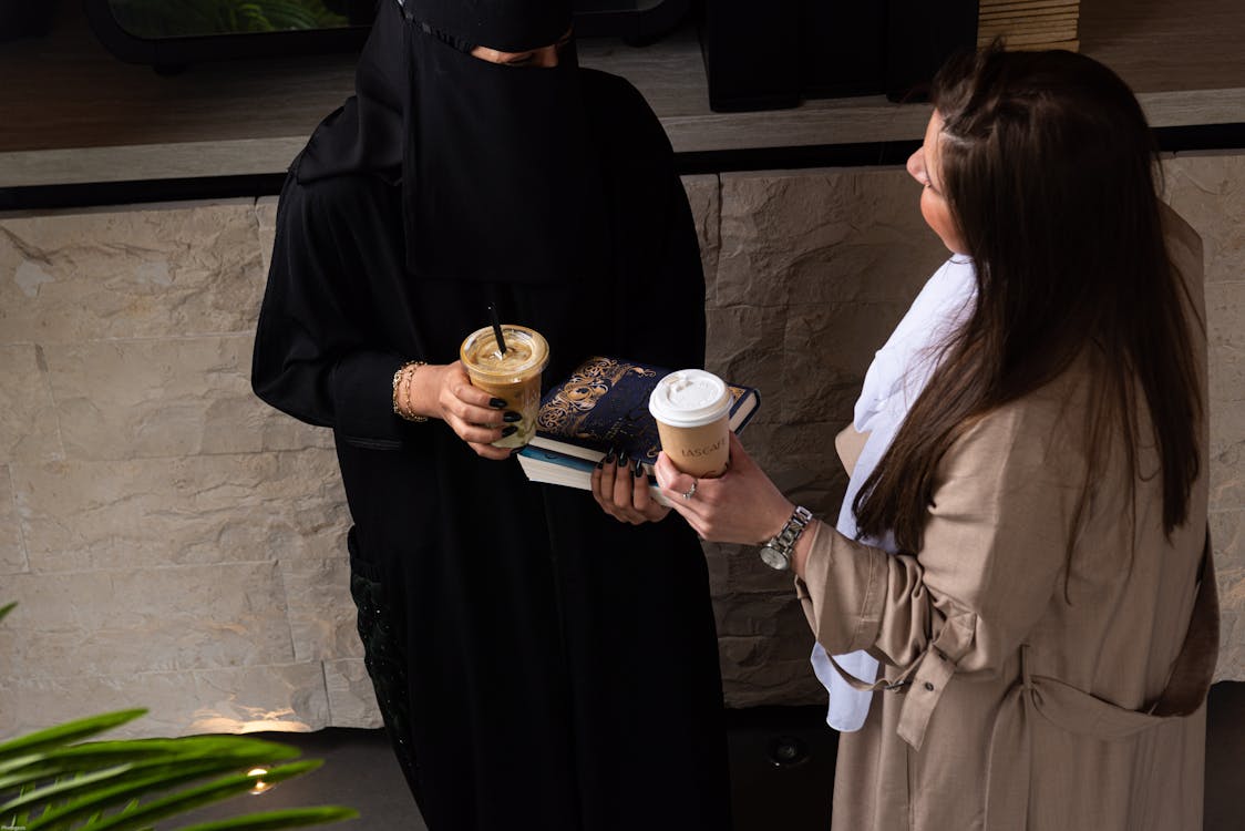 Women in Modesty Clothing Holding Coffee Cups · Free Stock Photo