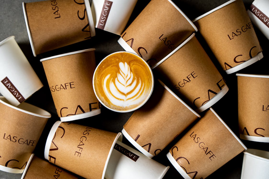 Coffee Surrounded by Paper Cups · Free Stock Photo