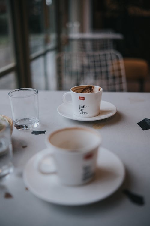 Coffee Cups on Saucers over a Table