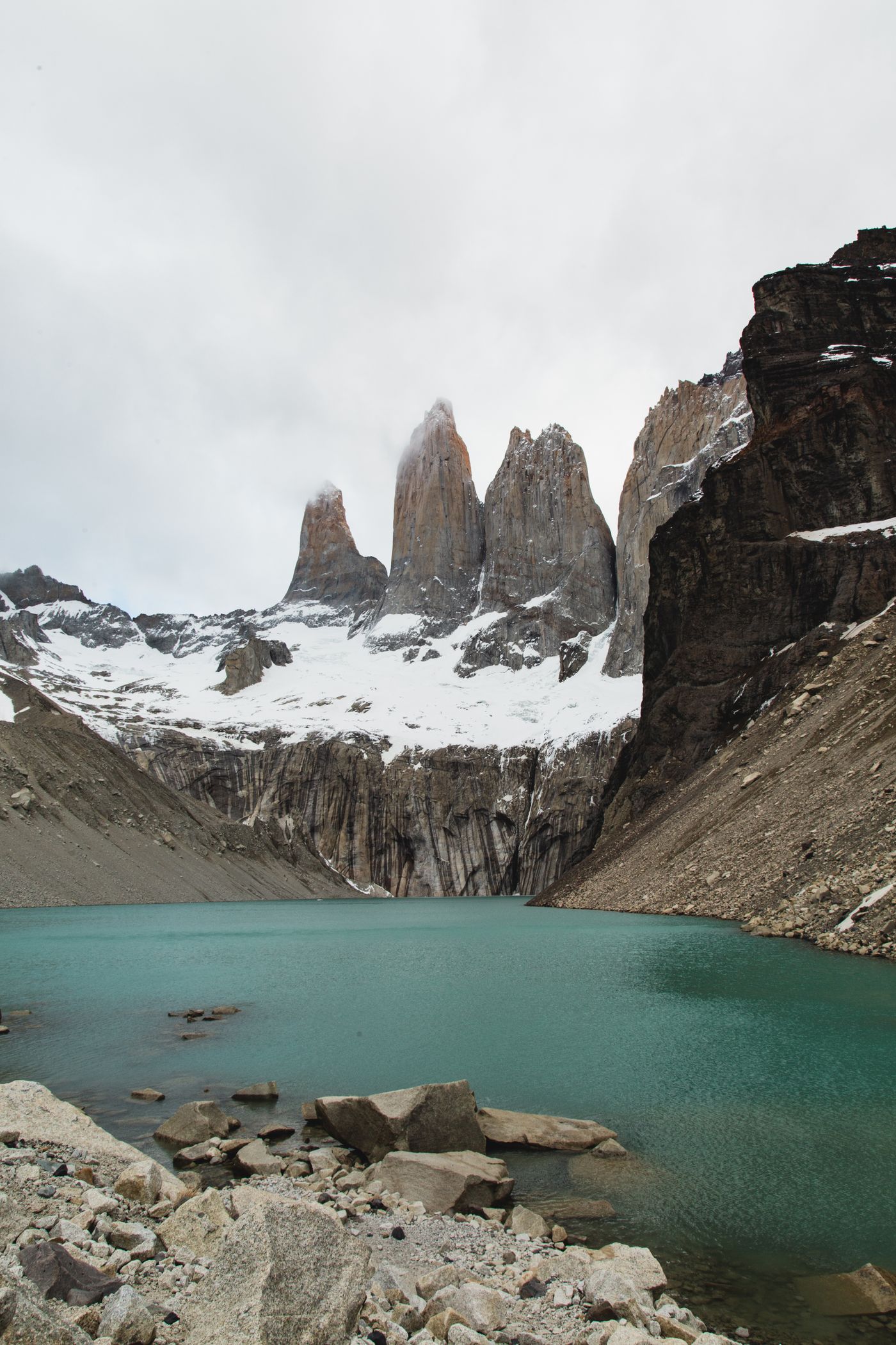 Snow-capped peaks of Torres del Paine, Chile, above a turquoise lake