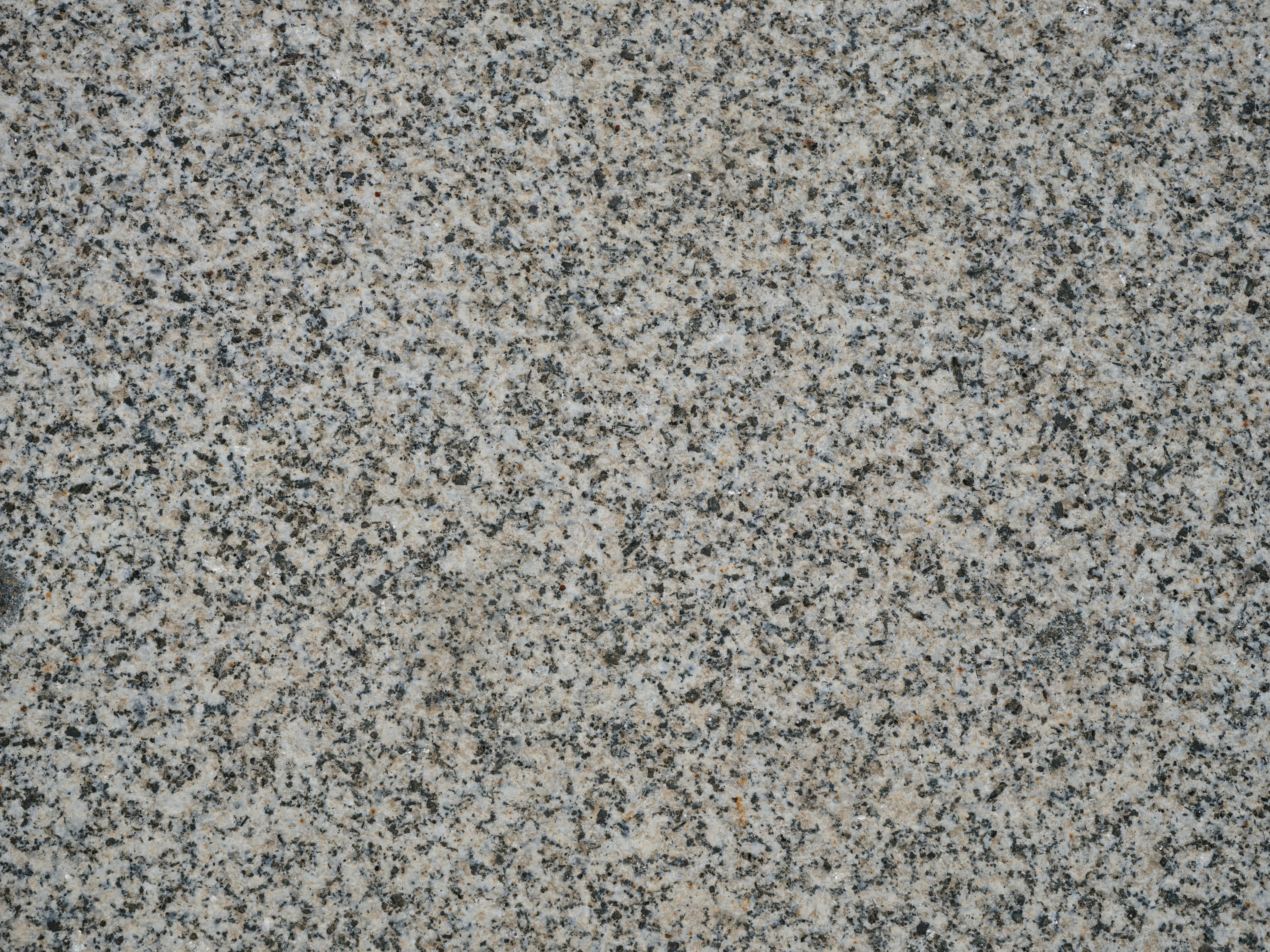 Close-up view of natural granite stone texture. Perfect for backgrounds or design projects.