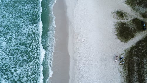 Aerial View of Ocean Waves on White Sand 