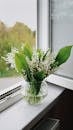 Bouquet of Lily of the Valley in a Glass Vase on a Windowsill