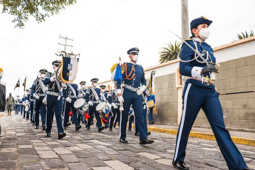 Free Ecuadorian military parade marches with musical instruments, showcasing tradition and safety during pandemic. Stock Photo