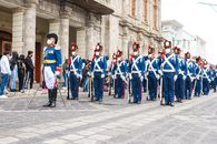 Men in Blue and Orange Uniform Standing on Gray Concrete Floor