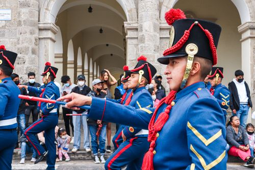 Free Vibrant military parade participants in traditional uniforms march through Latacunga, Ecuador. Stock Photo