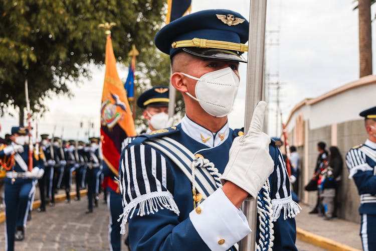 Man In Blue And White Uniform Wearing White Facemask