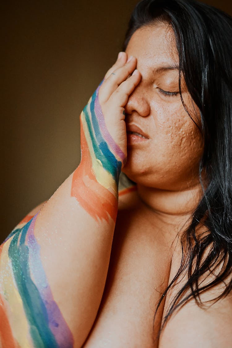 Young Overweight Woman Covering Face With Painted Hand