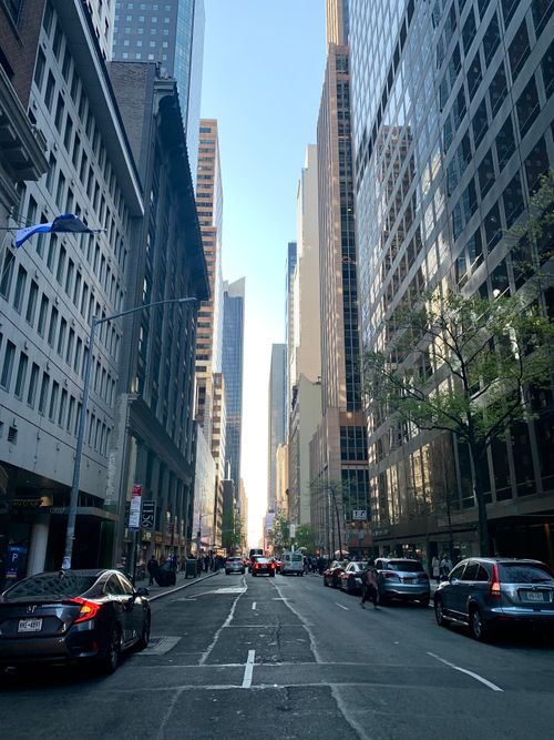 Free Dynamic street view of New York City's skyscrapers and bustling streets on a clear day. Stock Photo