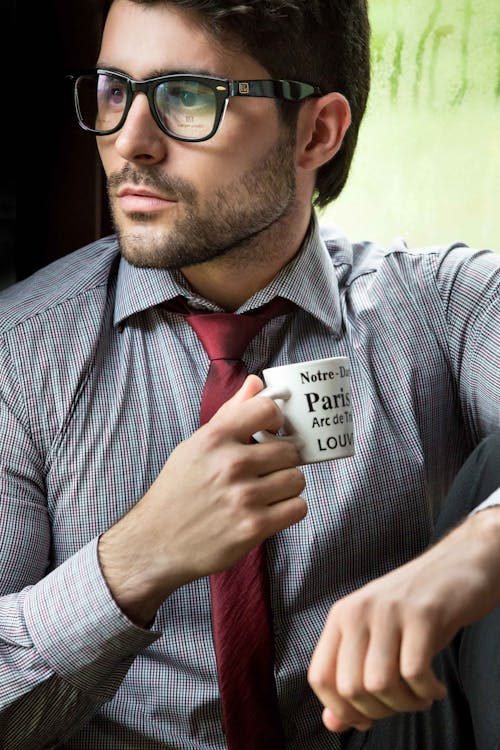 Man in Corporate Attire Holding a Cup 