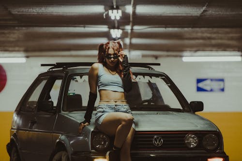 Free Woman in Black Tank Top and White Panty Leaning on Black Car Stock Photo