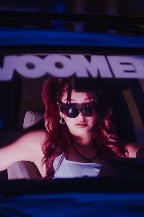 A Woman Inside a Car Wearing Sunglasses