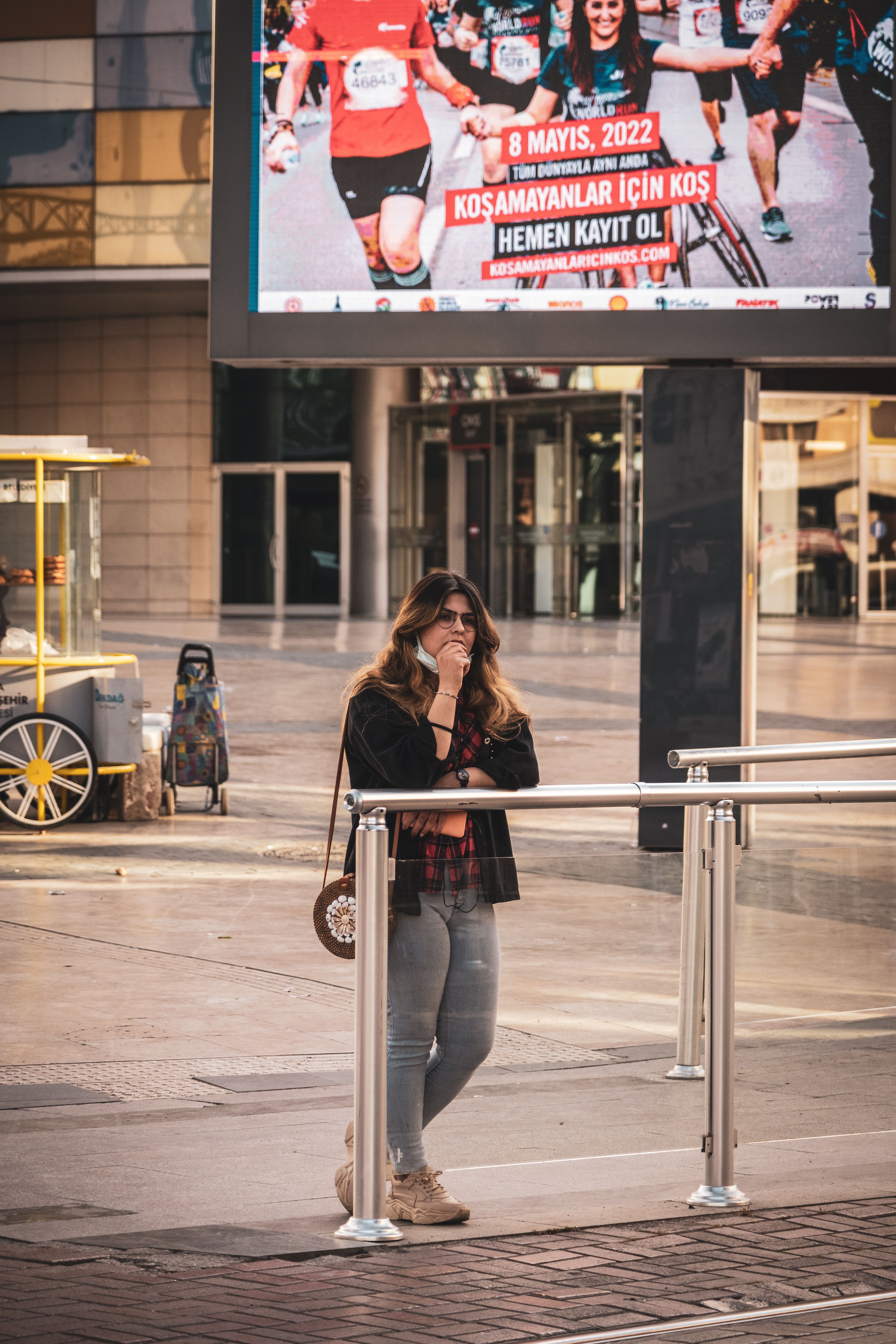 A Woman Standing Behind a Metal Railing · Free Stock Photo