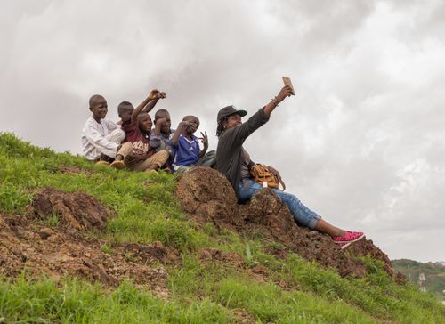 Free A cheerful group taking a selfie on a hill in Nigeria with lush greenery. Stock Photo