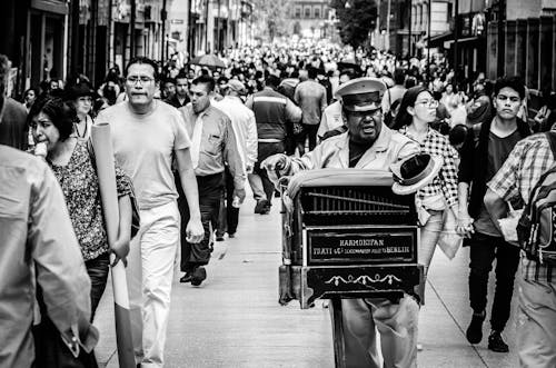 Musician Playing in a Busy Street