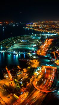 Stunning aerial night view showcasing Istanbul's illuminated cityscape and bustling harbor.