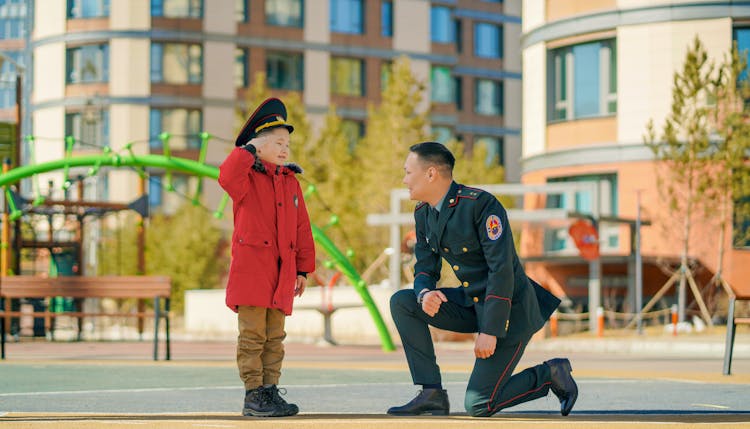 Boy Saluting To Smiling Soldier