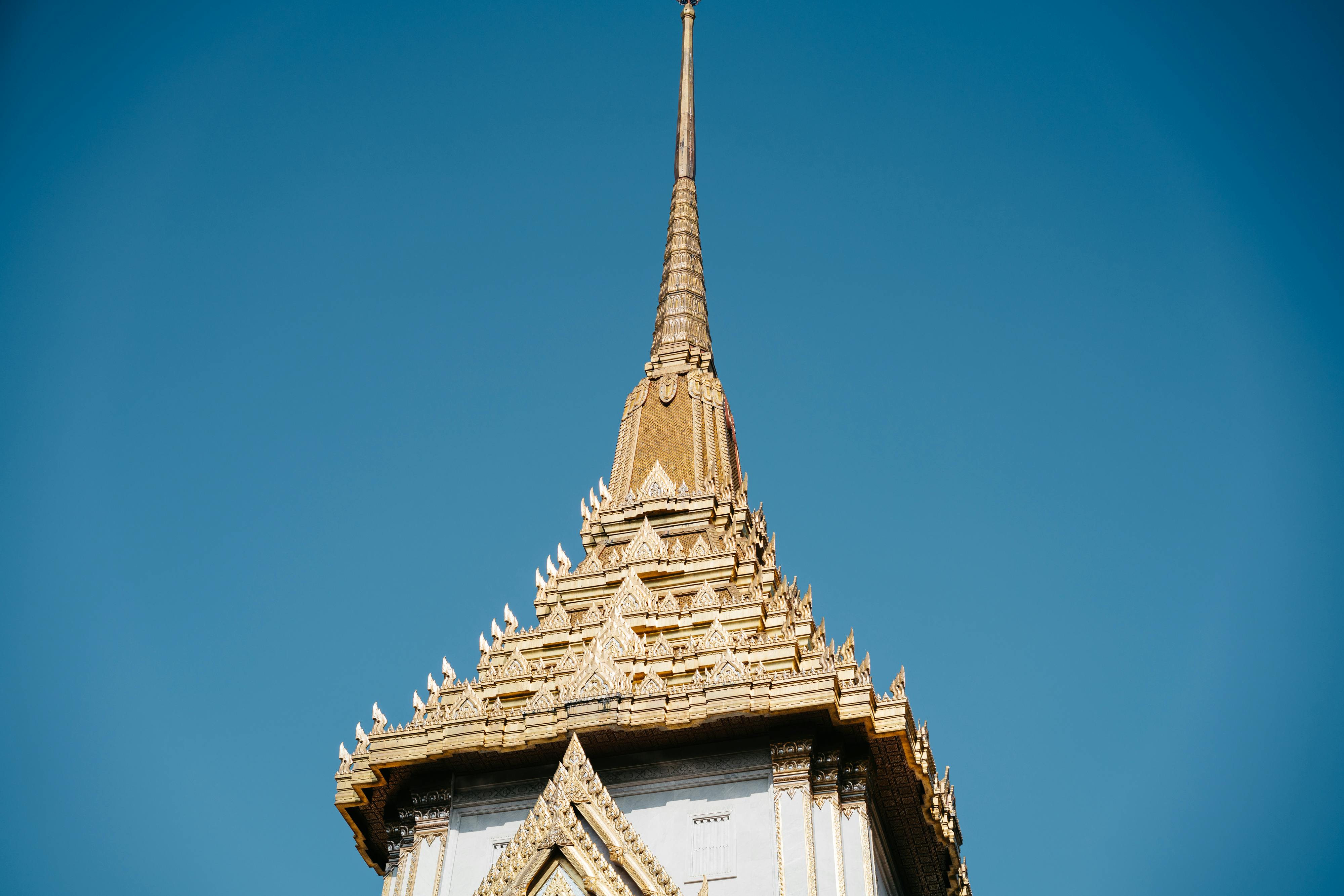 roof of wat traimit temple in bangkok thailand under blue sky