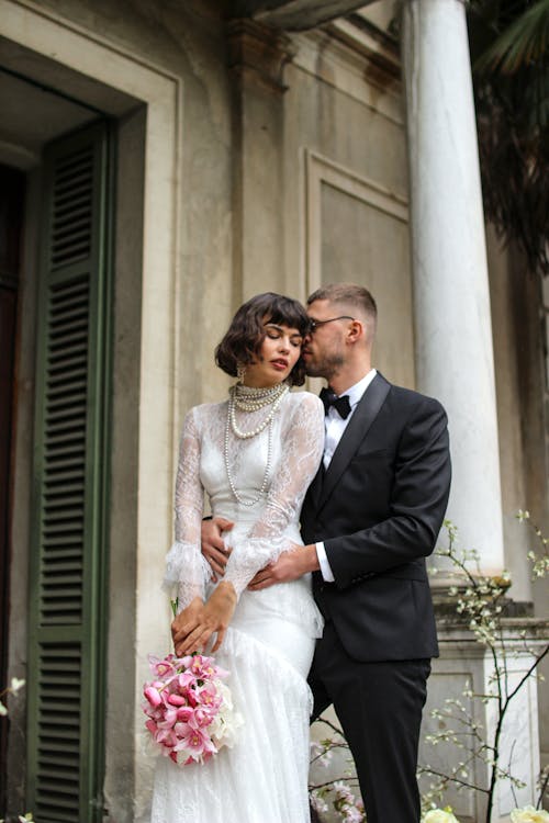 Newlyweds Posing in Suit and Dress