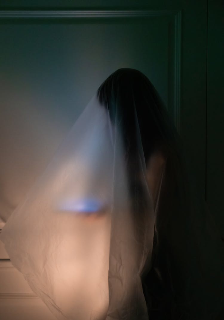 Silhouette Of Person Under Transparent Fabric