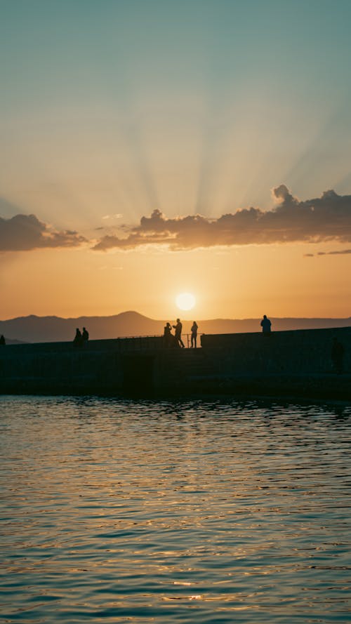 A Silhouette of People on a Pier during the Golden Hour